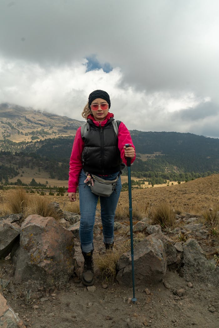 Mastering the First Impression: Your intriguing post title goes here Outdoor adventure of a woman hiking in scenic mountains under cloudy skies.