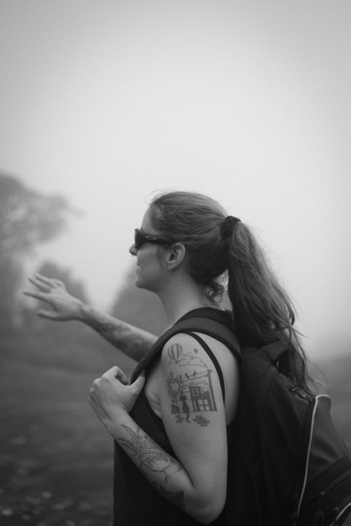 gallery-5 Woman hiking in foggy Minas Gerais, showcasing adventure and exploration.